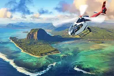 Helicopter beside a panoramic view of Le Morne Brabant, the peninsula and its turquoise lagoon and reef.